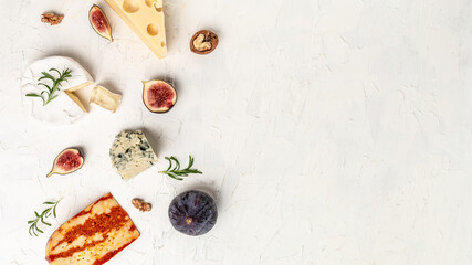 Fototapeta na wymiar assortment of cheese, camembert, emmental, marble delicous cheese, blue cheese. Corner border of a selection of cheeses, figs, nuts and honey. place for text, top view