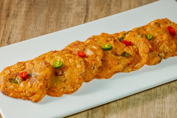 kimchijeon, Korean food kimchi pancake : Slices of well-fermented kimchi mixed into a flour batter and pan- fried. Finely chopped pork, squid, and clam meat may be added to the batter as well.