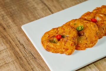 kimchijeon, Korean food kimchi pancake : Slices of well-fermented kimchi mixed into a flour batter and pan- fried. Finely chopped pork, squid, and clam meat may be added to the batter as well.