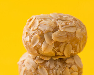 sweet Oat ball made as a diet healthy food you can eat it as a desert without concerning about getting fat  close shot with a yellow background