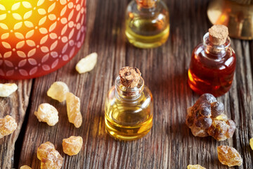 A bottle of frankincense essential oil with frankincense resin crystals