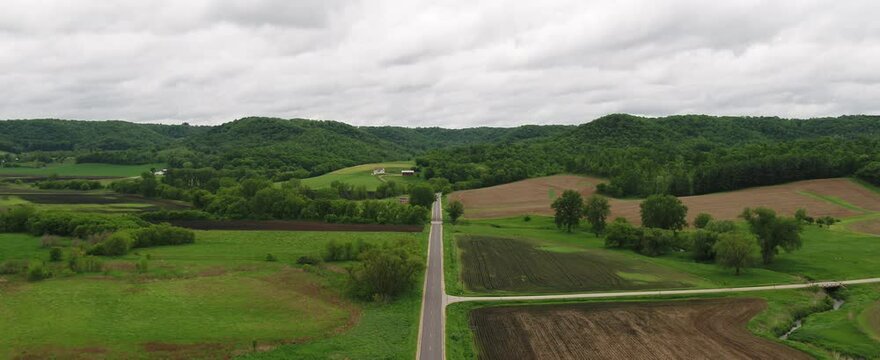 Road through Rolling Green Hills in Farmland (Wisconsin / Drone Video)