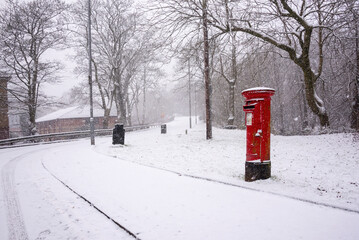 Red post box in snow in rural Scottish setting. - Powered by Adobe