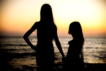 silhouette of a couple on the beach at sunset