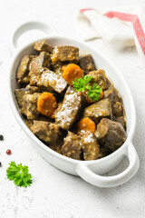 Beef carrot spiced liver in ceramic dish. Copy space.