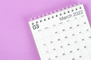 March 2022 desk calendar on light purple background.