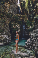 Woman in Swimsuit Enjoying Wild Waterfalls