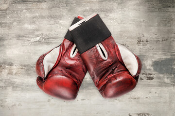 Pair of vintage boxing gloves on grunge grey background