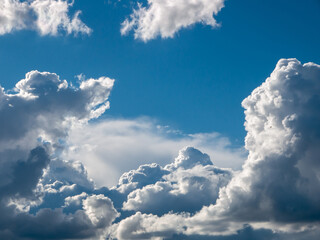 White fluffy epic clouds on blue sky