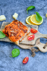 Fish bake preparated in Ticino style with sweet gorgonzola cheese and tomato crust