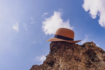 Sun hat sitting on a rock on a beach in Bali