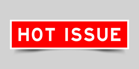 Sticker label with word hot issue in red color on gray background