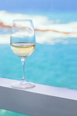 White wine glass on the hotel balcony with tropiucal sea view in exotic country