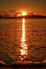 Fototapeta na wymiar Sunrise from a roller coaster on the beach