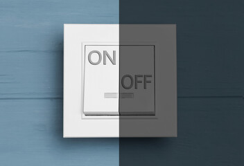 Turned ON and OFF light switch on blue wooden background