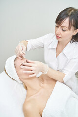 Injection at spa salon. Doctor hands in gloves. Closeup. Pretty female patient. Beauty treatment....