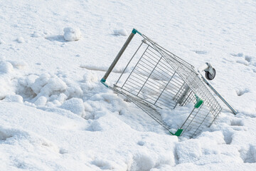 Shopping basket thrown into the snow 