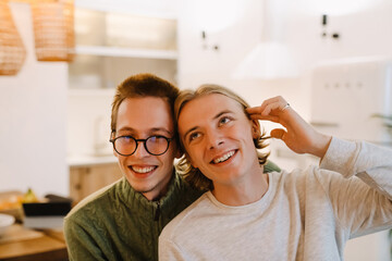 European gay couple hugging and smiling while spending time together