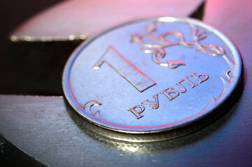 Russian coin in denomination of one ruble against the background of a wrench. close-up