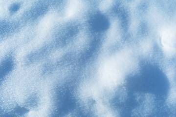 Background of snow illuminated by sunlight, flat texture
