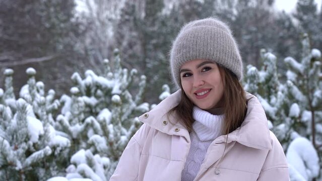 Young attractive girl smiling in the winter in the forest. Slowmo