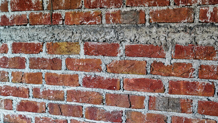 Freshly made brick wall with the mortar of cement, sand and water, selective focus