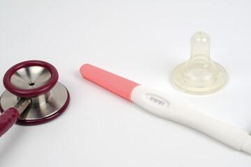 Pregnancy test device to determine a pregnant woman. Health and medicine concept with stethoscope.