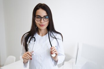 Young beautiful woman doctor with a stethoscope around her neck in the office