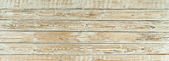 Texture of old shabby boards. Table with white erased paint. Background from old light boards close-up.