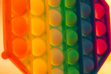 Close up shot of octagon pop it toy on colorful background. Concept