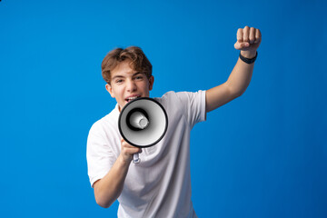 Teen boy making loud announcement against blue background.