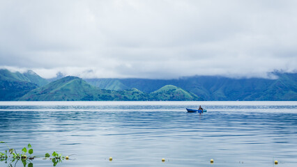 A faraway fisherman is at work