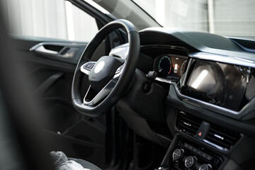 Modern car interior, steering wheel and dashboard