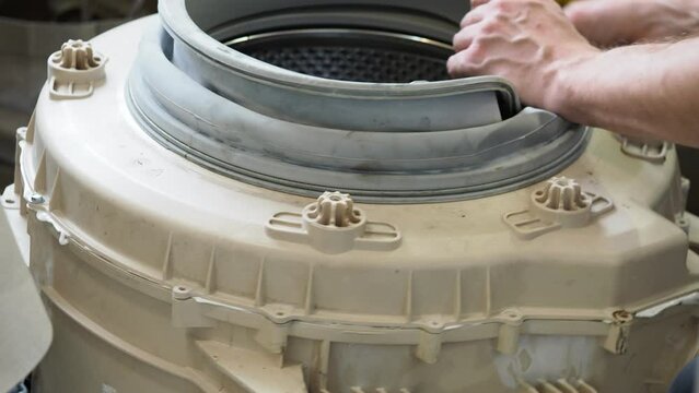 master services man disassembles into a washing machine  repair