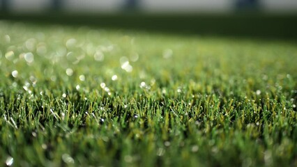 Motion above bright green artificial grass covering football field in closed sports arena at modern stadium extreme closeup - Powered by Adobe