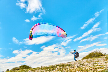 Preparing for paragliding in a field under a blue sky, Cordoba, Argentina, South America