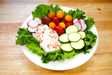 Fresh Salad Lunch with Seafood salad, tomatoes, radishes and Zucchini Slices
