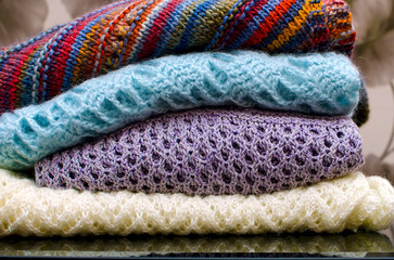 Folded clothes in openwork knitting. Self-knitted clothes.