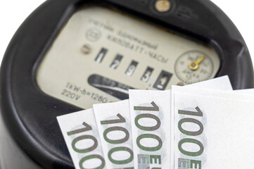 Euro banknotes money near electricity meter on white
