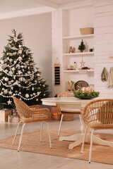Cozy dining room interior with Christmas tree and festive decor