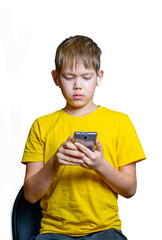 boy in wireless headphones playing on the phone on a white background