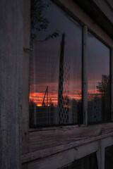 Fototapeta na wymiar Sunset mirror in window at Latvia village