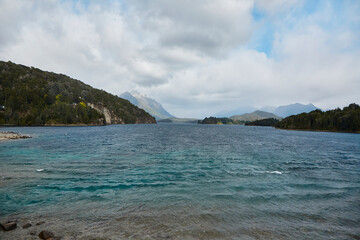 Fototapeta premium Lake of the Argentinean Patagonia between mountains of the Andes Mountains. Chain of mountains and lakes of melting ice and glaciers with cloudy skies.