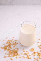 Soy milk in glass and soy bean isolated in white background