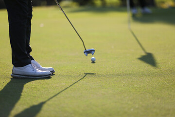 Young male golfer player on golf course