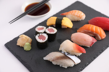 Sushi Set nigiri and sushi rolls with soy sauce and chopsticks Japanese food isolated in white background