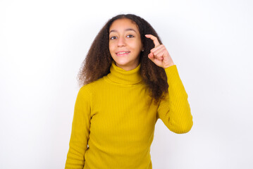 beautiful teenager girl wearing yellow sweater standing against wite background pointing up with fingers number nine in Chinese sign language Jiu