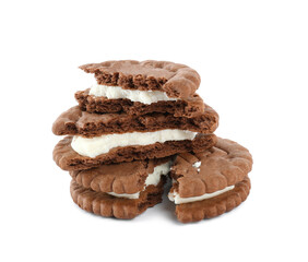 Broken tasty chocolate sandwich cookies with cream on white background