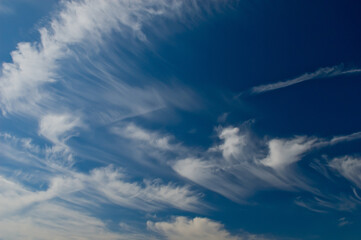 Soft cirrus clouds driven by wind in a blue sky