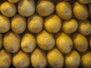 Close-up shot of Neatly stacked large Russet potatoes on a stall